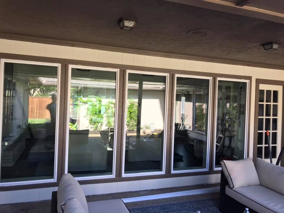 New white vinyl windows installed on a home exterior