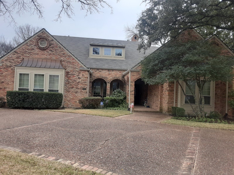 Newly installed white replacement windows on a home exterior